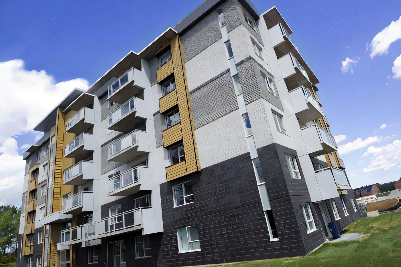L’immeuble du Logix à Laval-des-Rapides : brique grise et noire, panneaux jaunes, balcons vitrés, ciel bleu